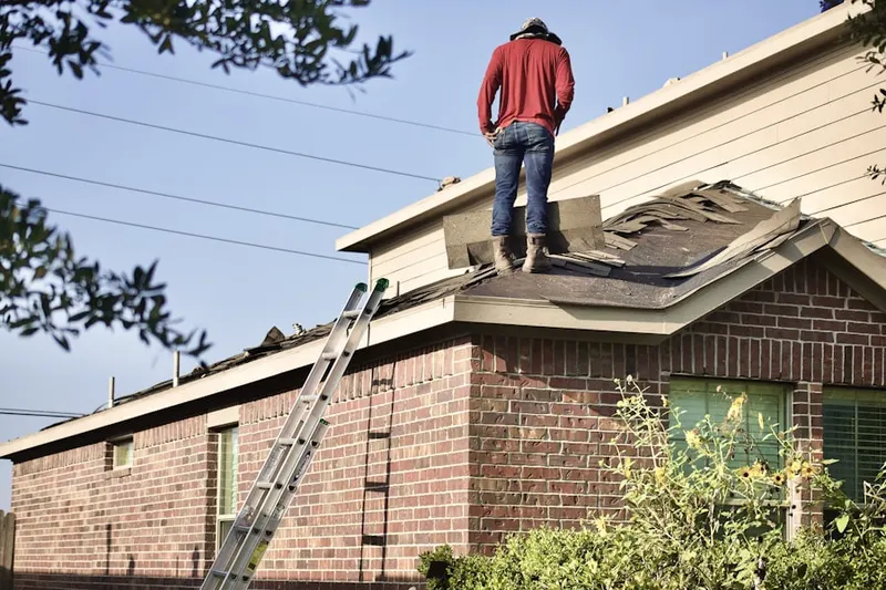 Professional roofer working on a residential roof in Pleasantview